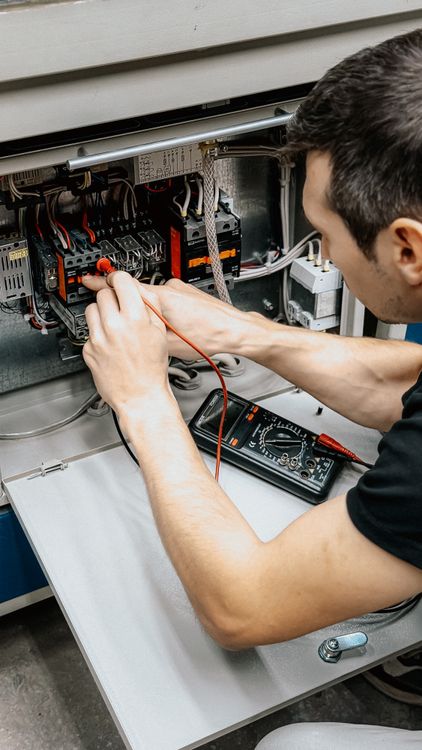 Electrician installing a home electrical panel